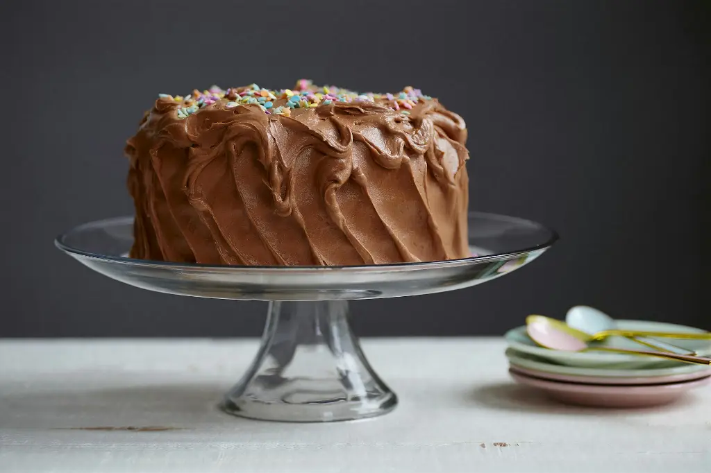 Torta Con Crema brown cake on clear glass cake stand